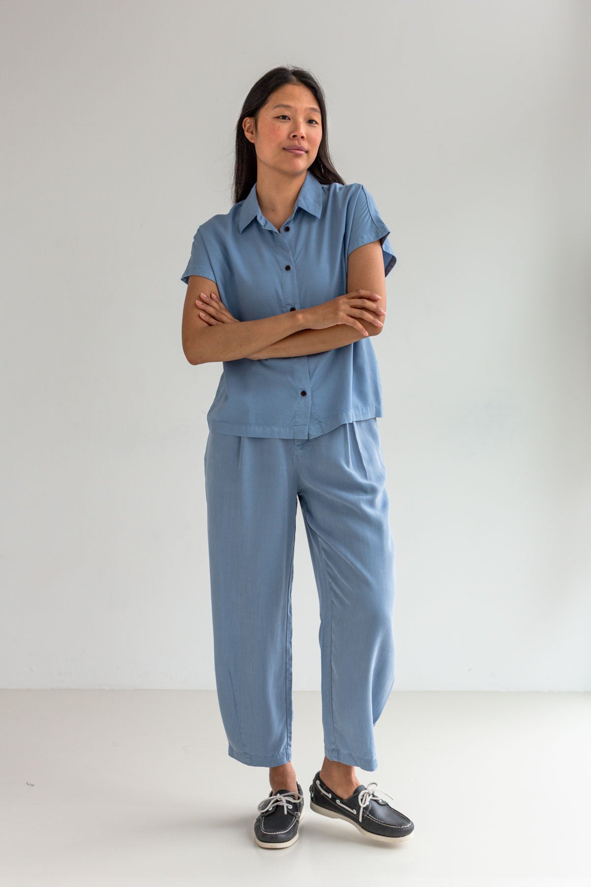 Denim blue lyocell pants women blue shirt full body view front