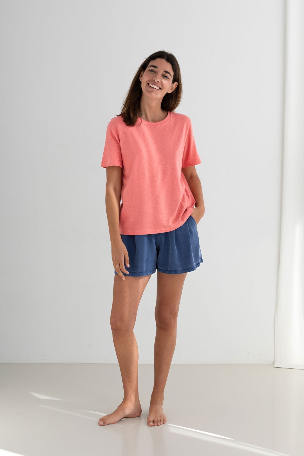 Pink roundneck top women blue shorts full body view front