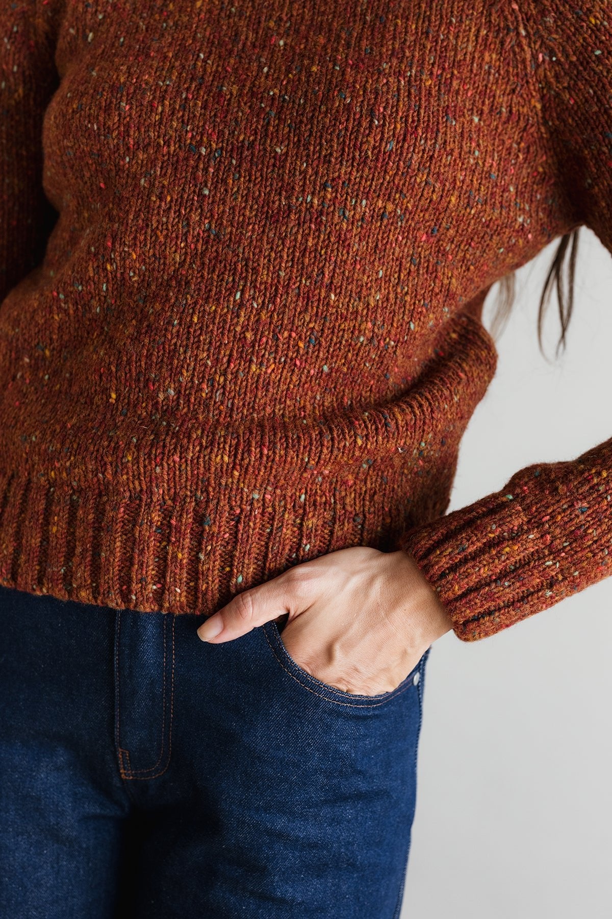 Brown copper knitted sweater and blue jeans