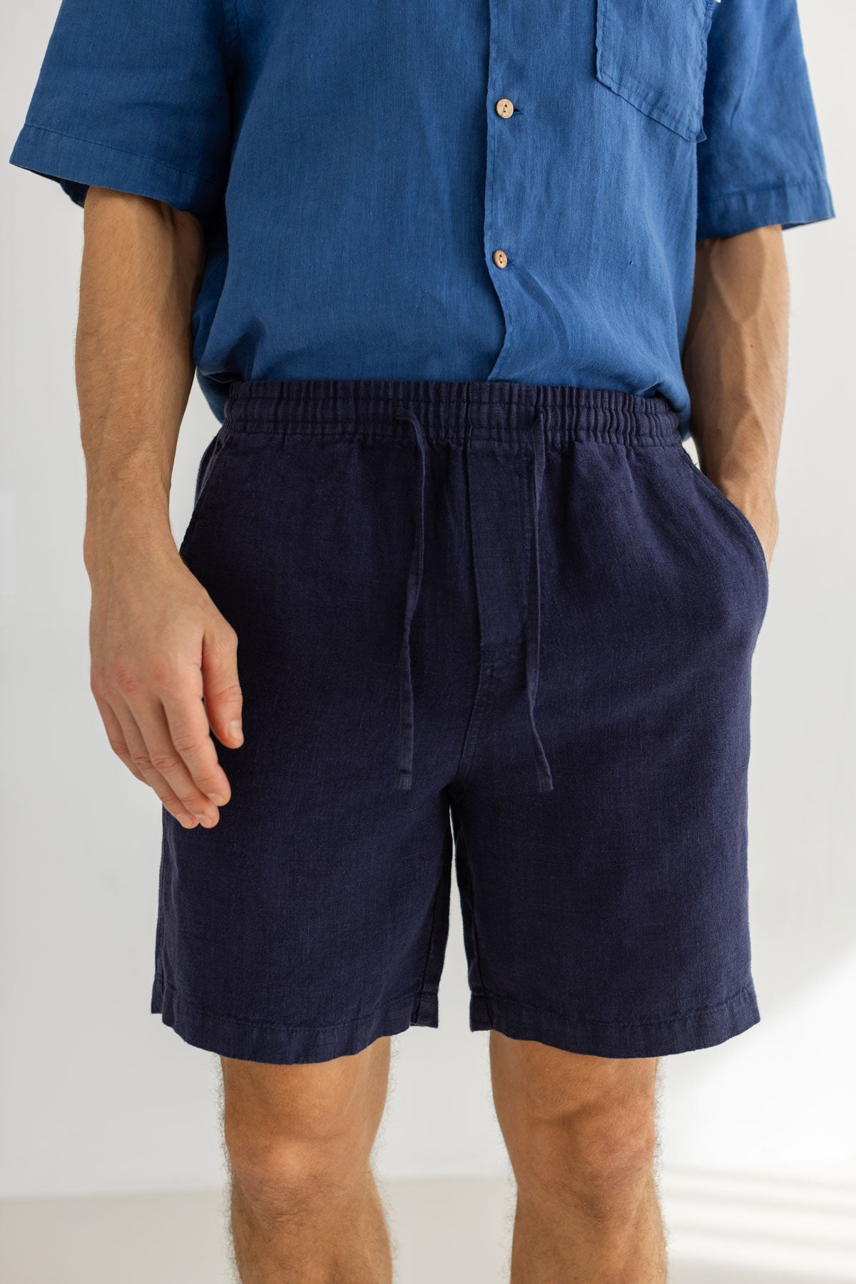 Navy blue heavy linen shorts men blue shirt wear view front