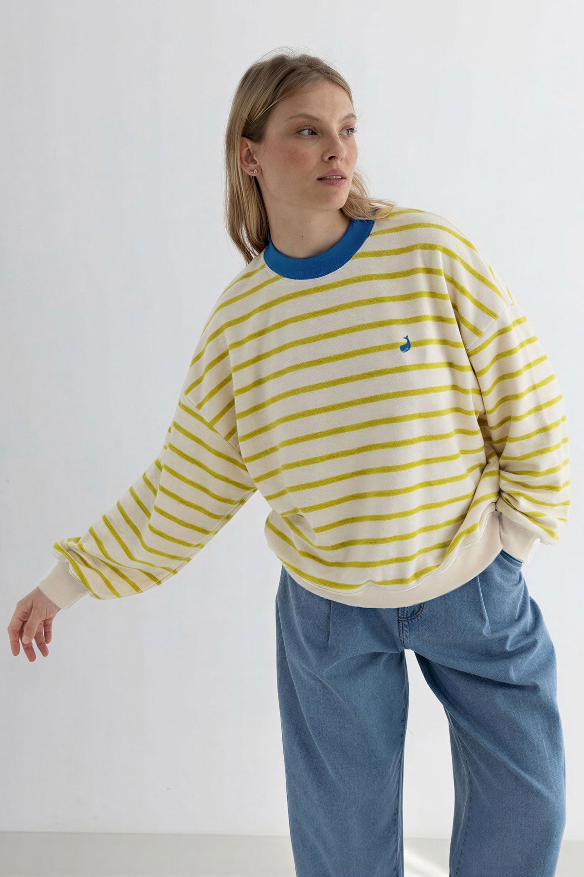 Golden green striped sweatshirt women denim trousers wear view front