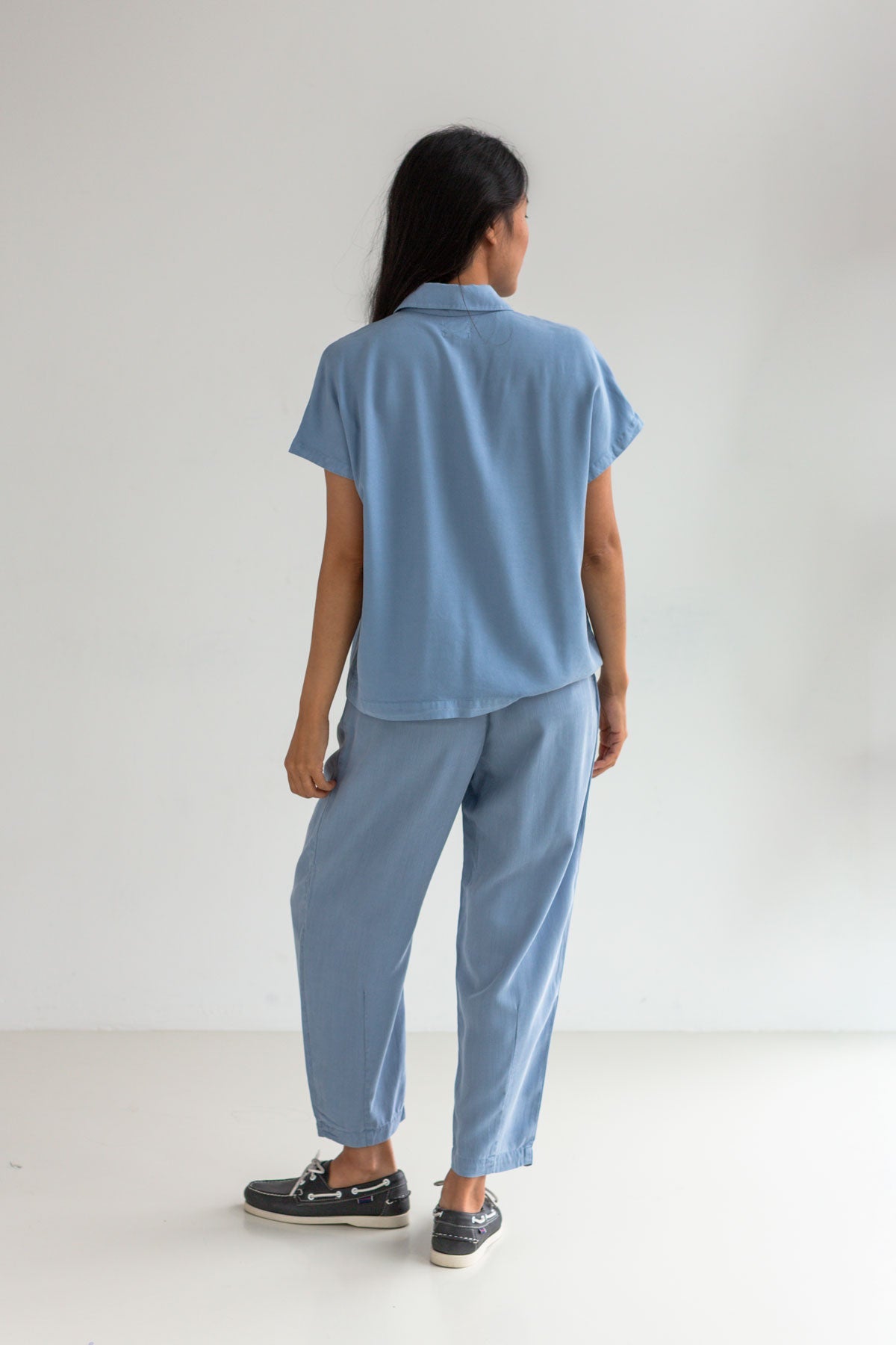 Denim blue lyocell pants women blue shirt full body view back