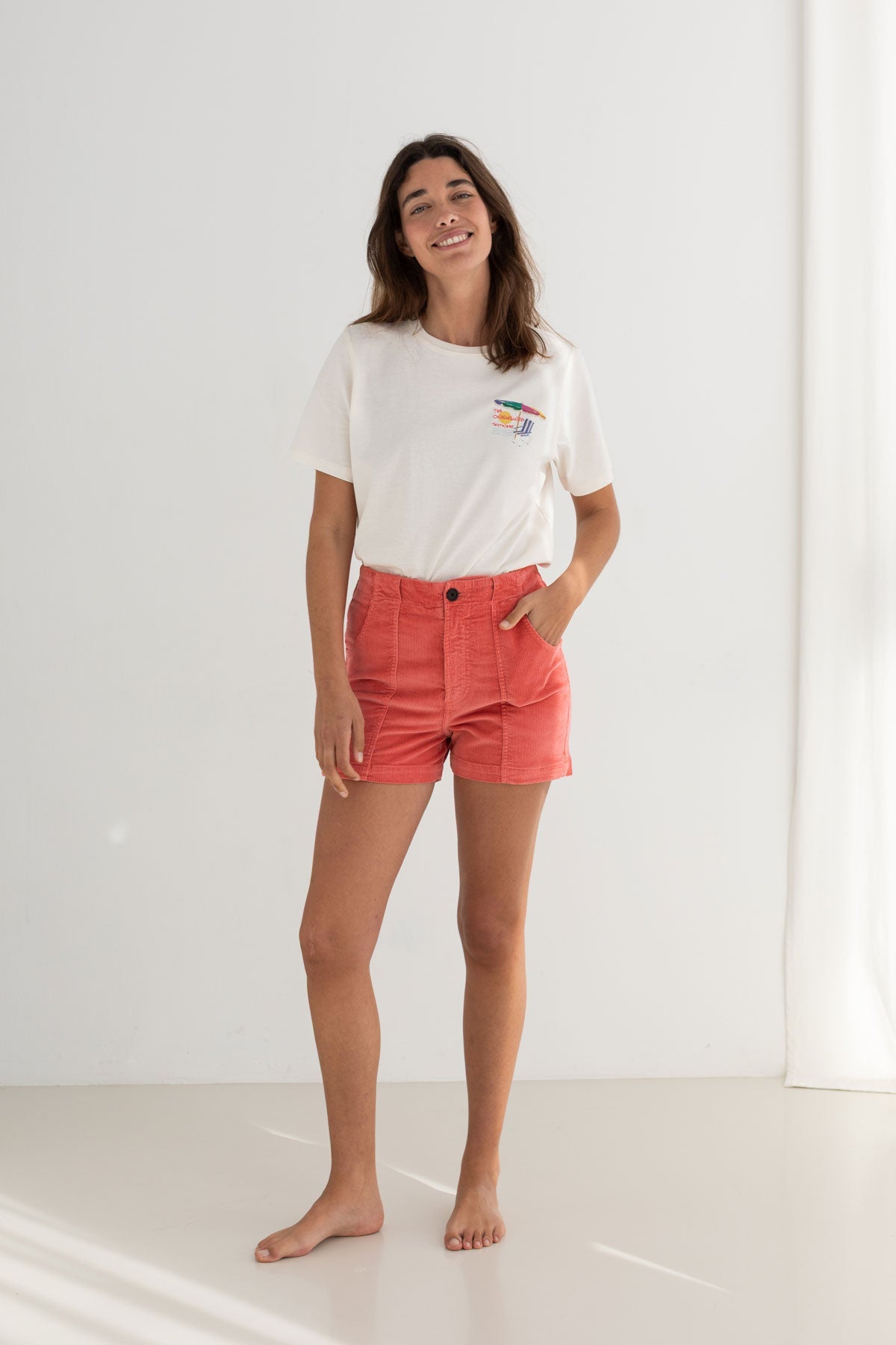 Pink corduroy shorts women off white tshirt full body view front