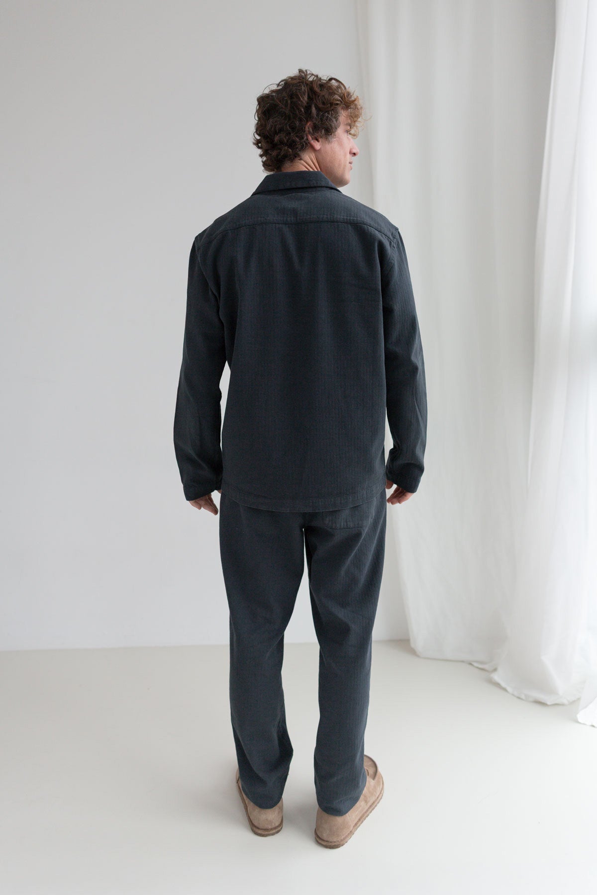 Dark navy organic cotton jacket men navy pants full body view back