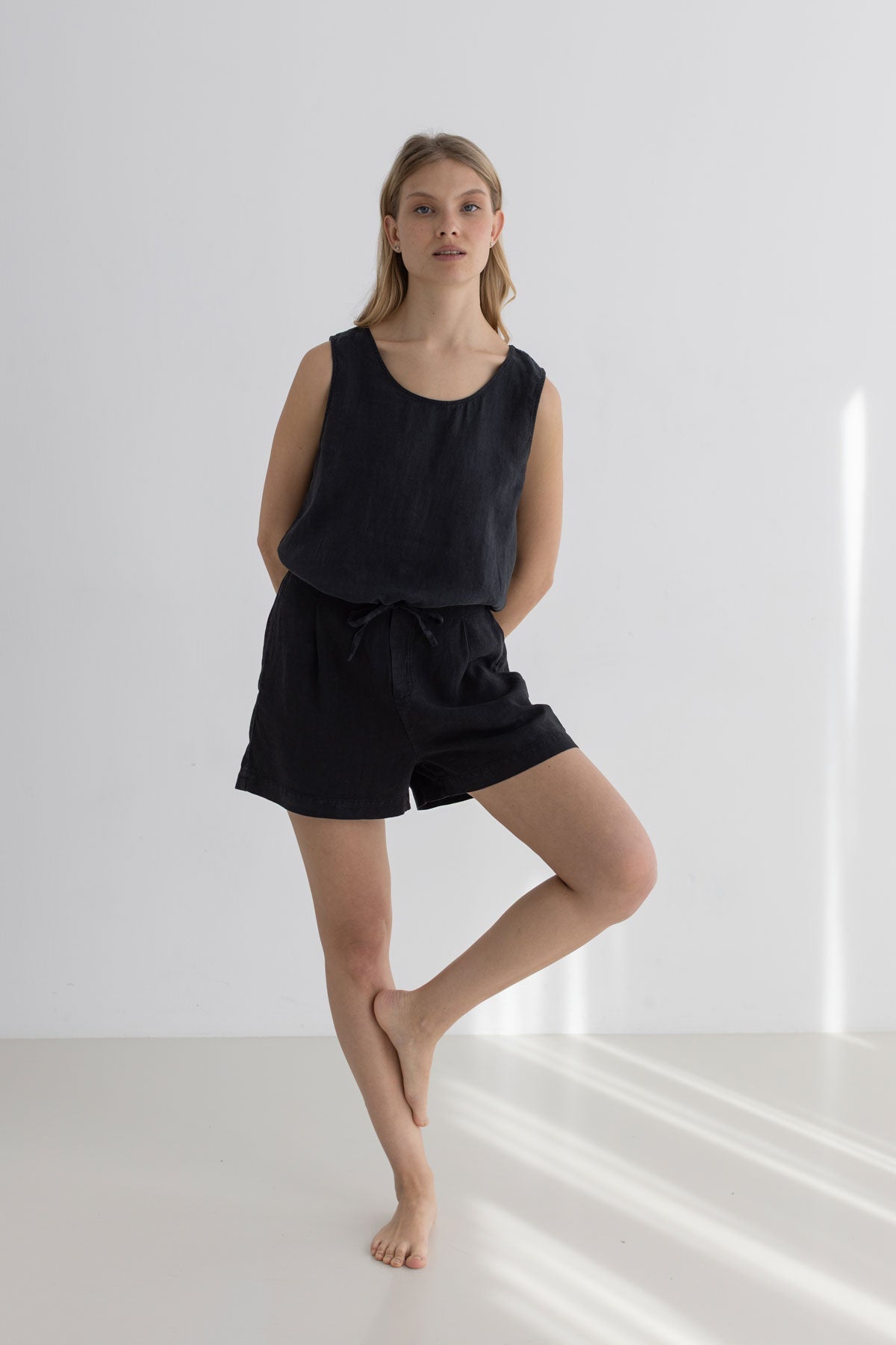 Black linen shorts women black shirt full body view front