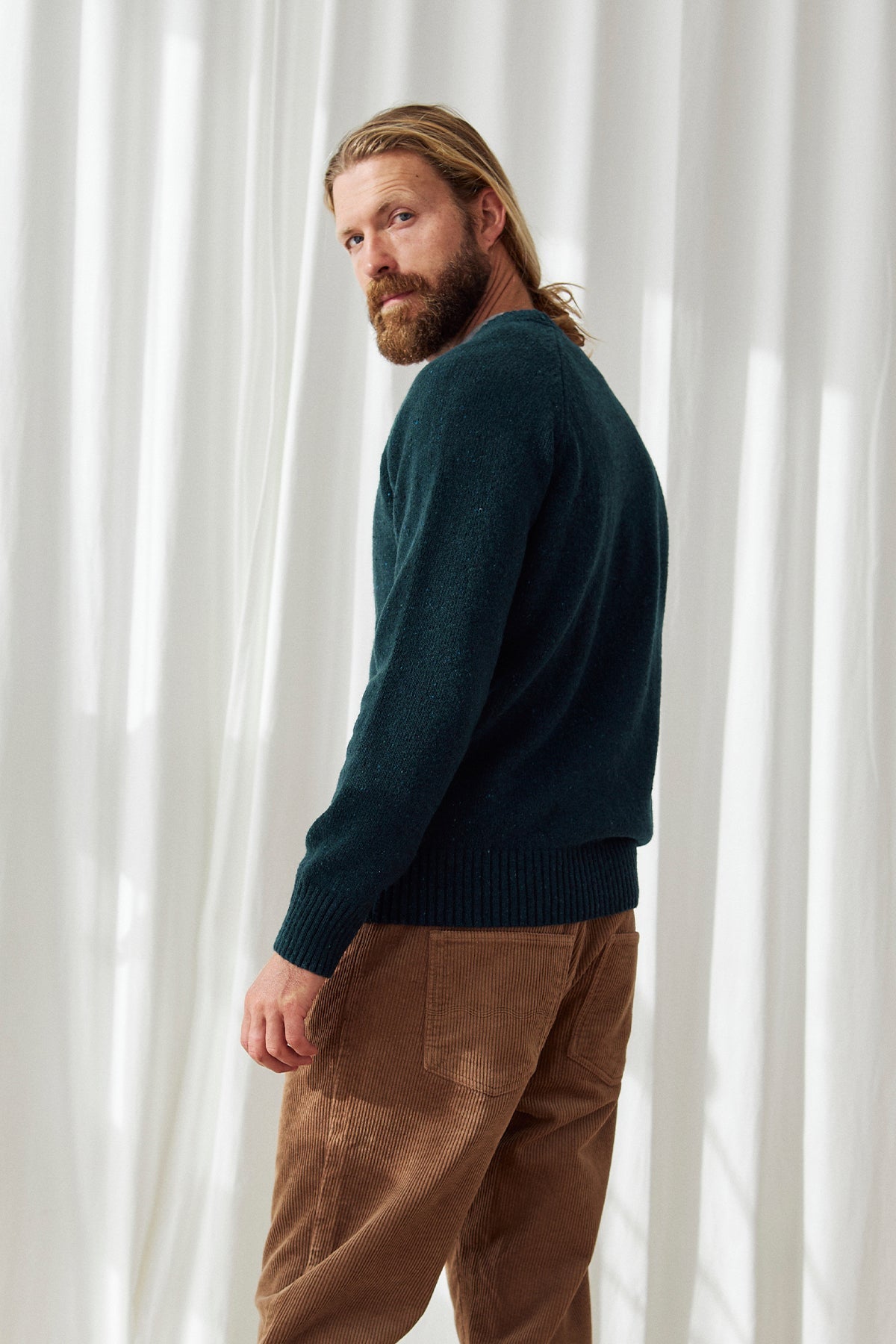 Back view of sustainable men’s green wool sweater