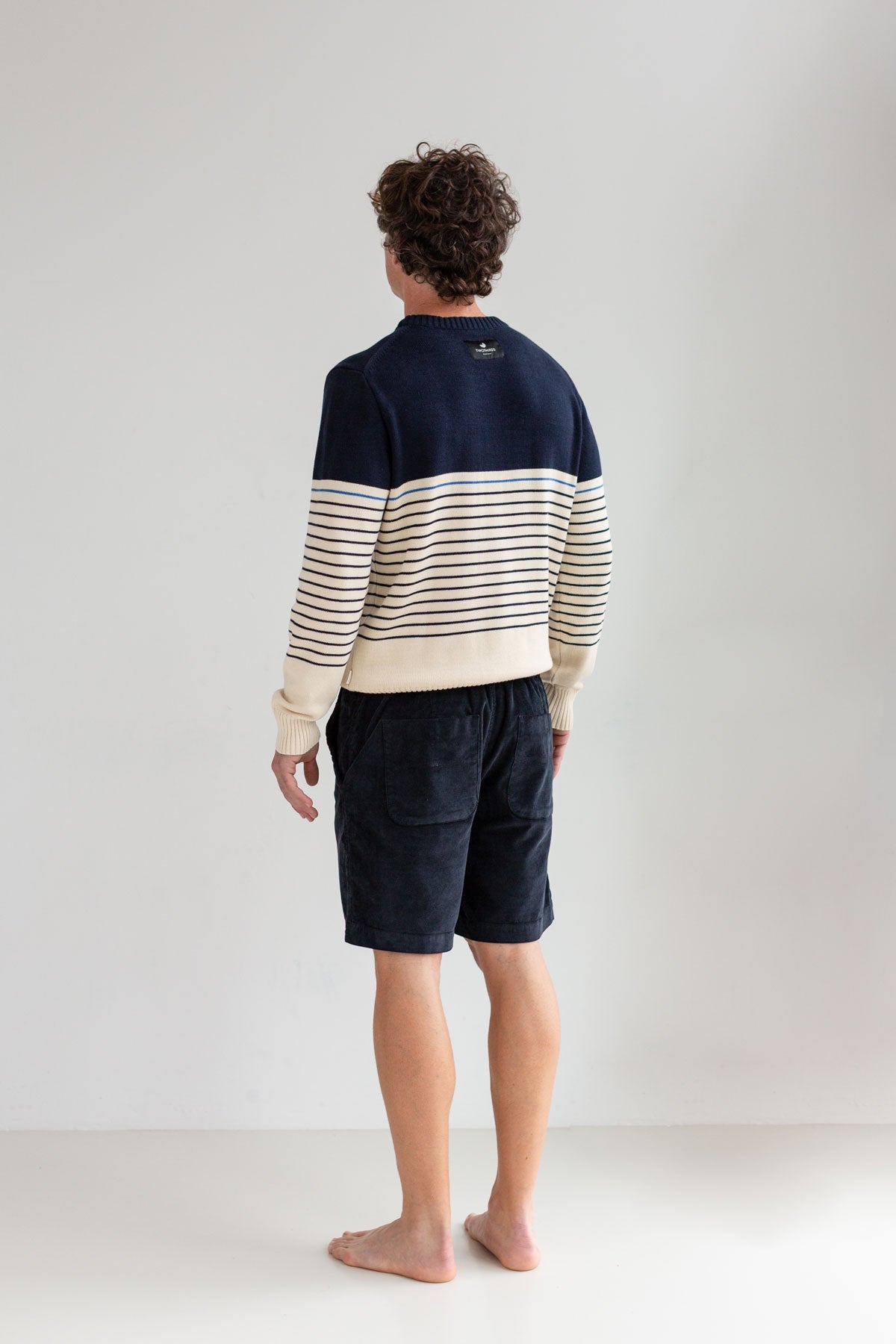 dark navy micro corduroy shorts men striped sweater full body view back