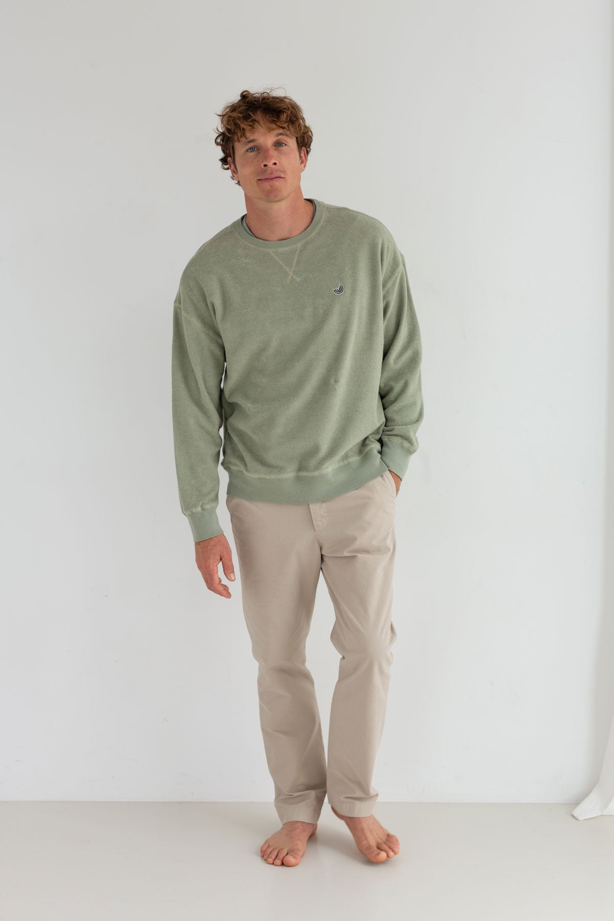 Light green sweatshirt men light pants full body view front