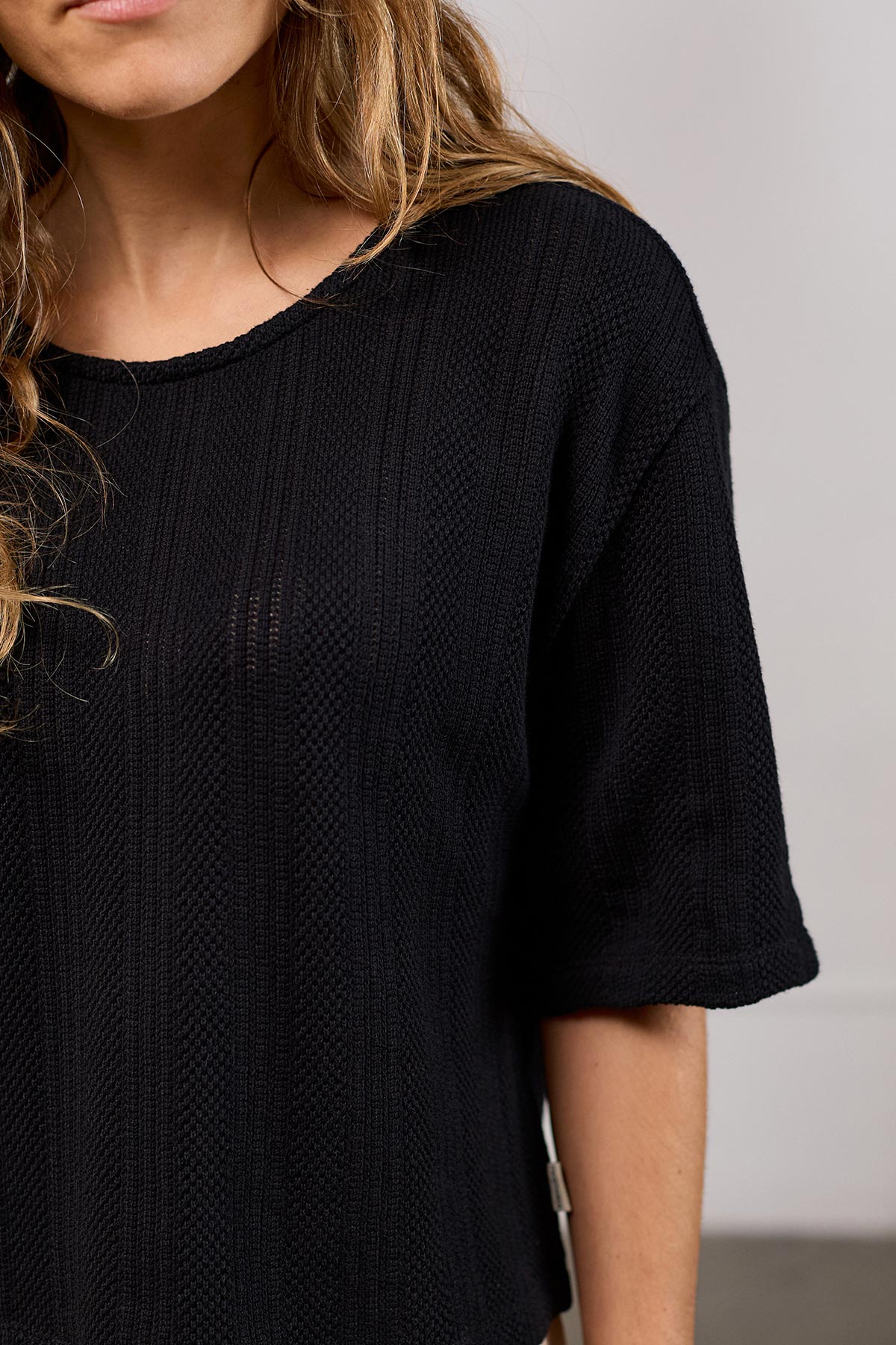 meta-hover, black openwork knit tee
