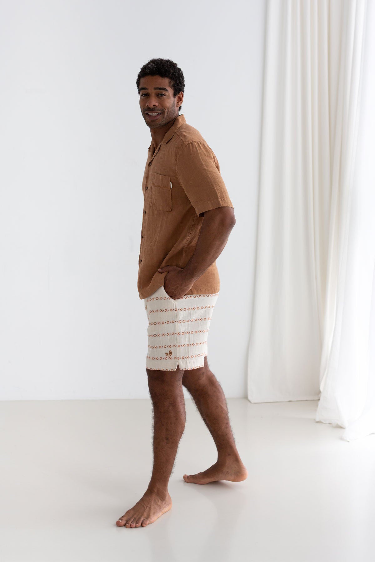 Adobe Guayabera shirt men light pants full body view front