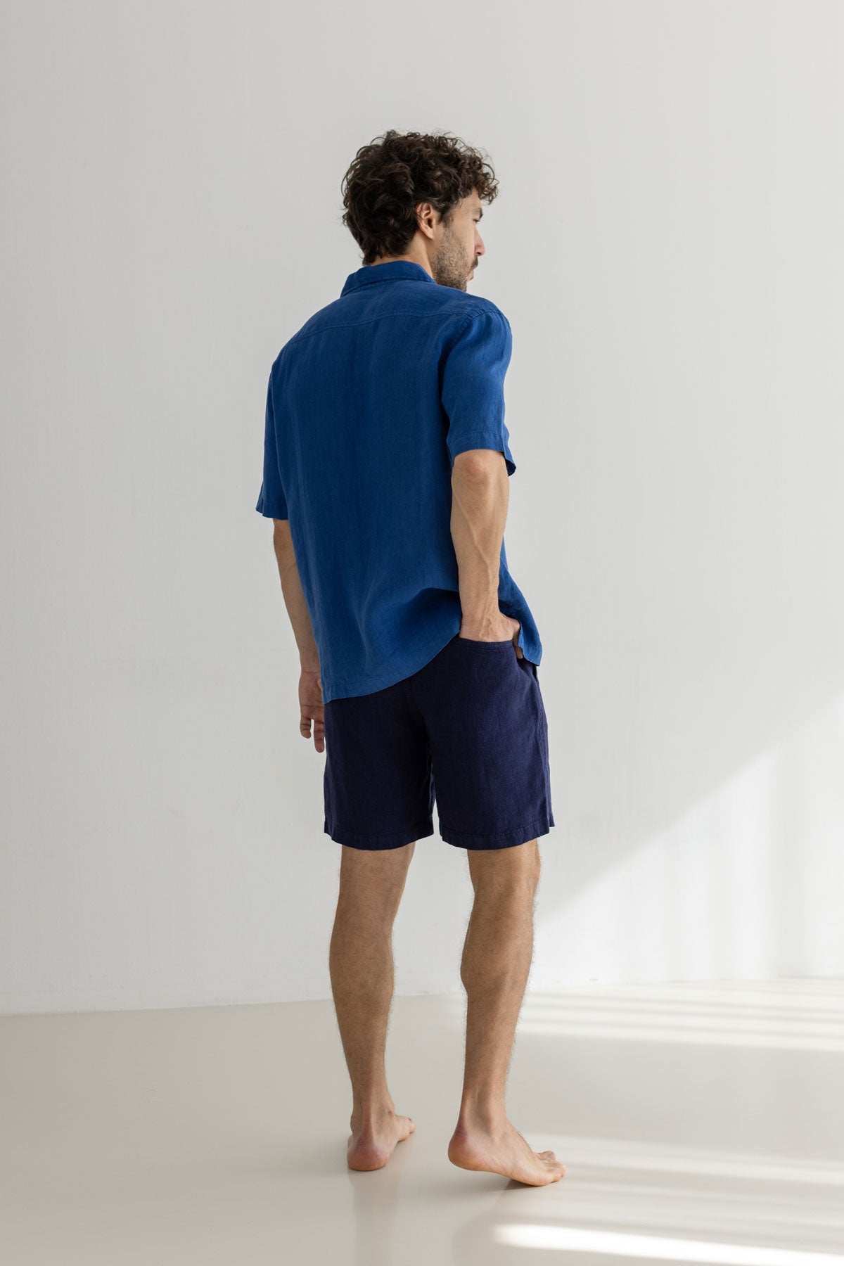 blue linen shirt men navy pants full body view back