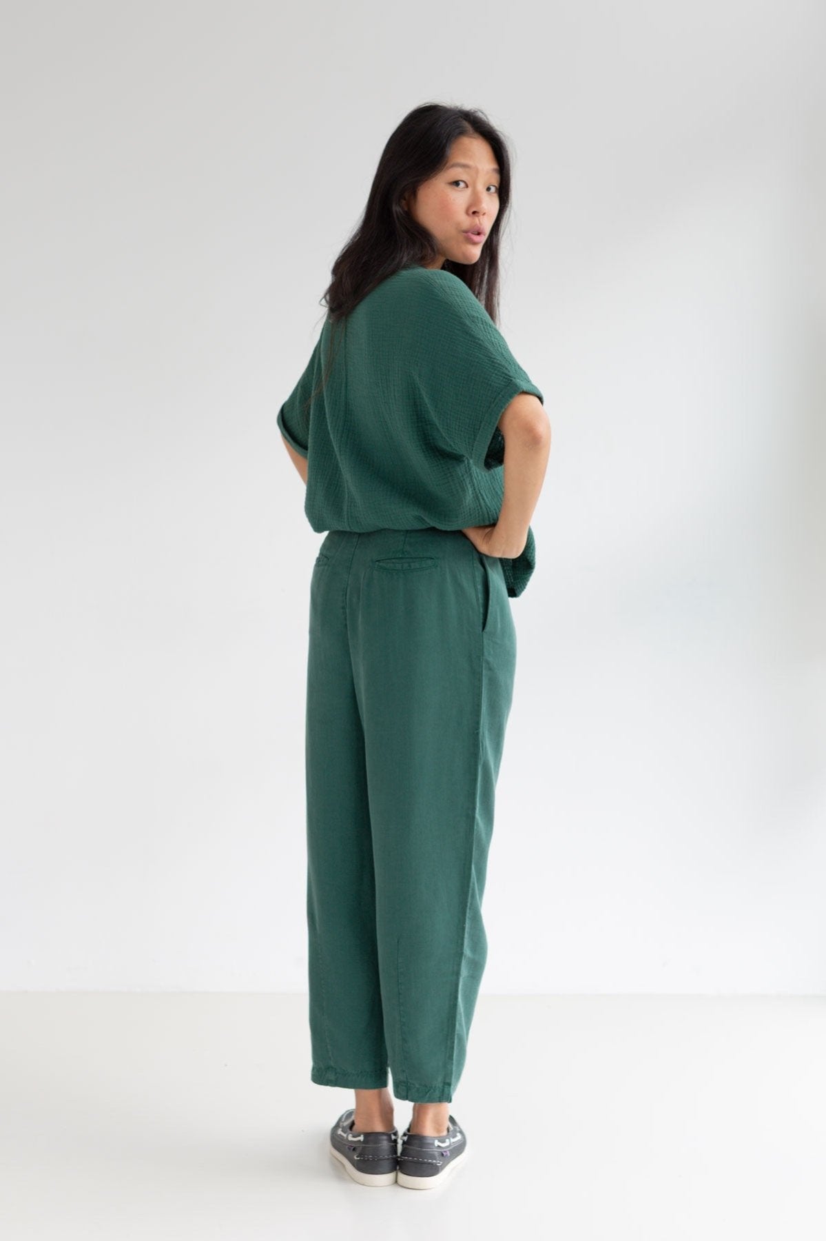 Dark green lyocell pants women green shirt full body view back
