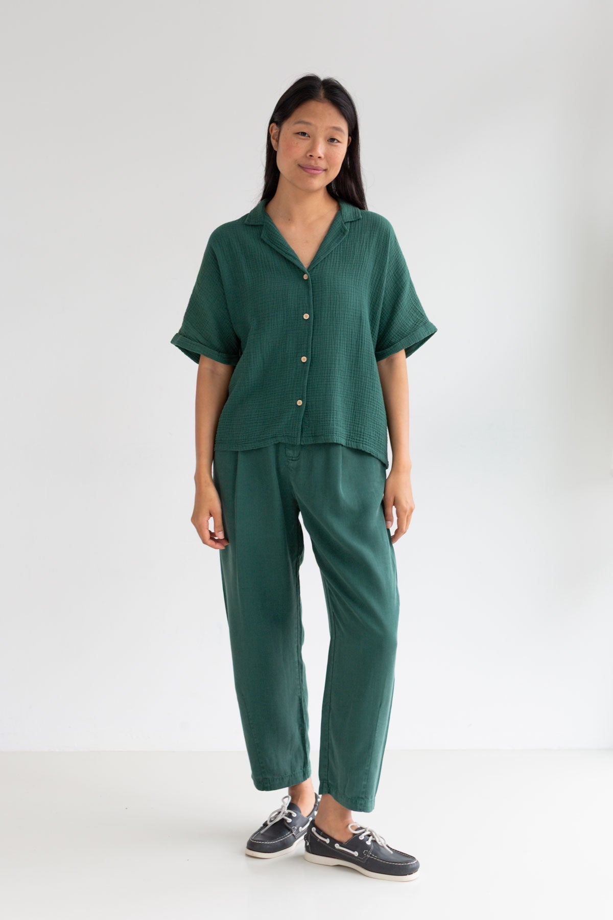 Dark green lyocell pants women green shirt full body view front
