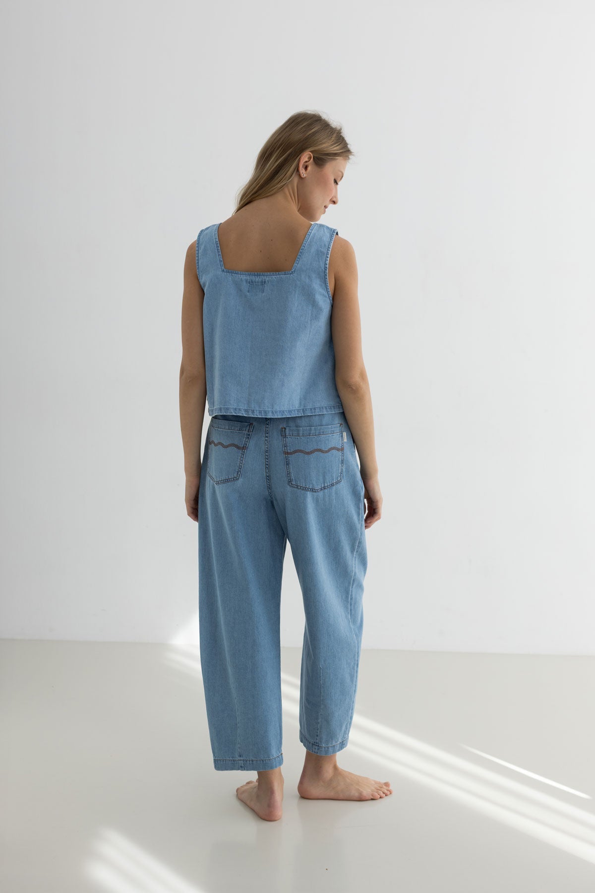 Light blue denim shirt women denim trousers full body view back