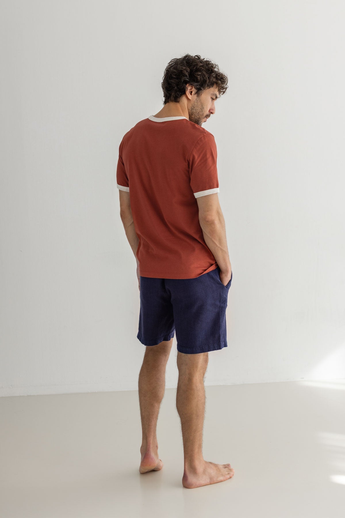 Red ochre tshirt men navy shorts full body view back