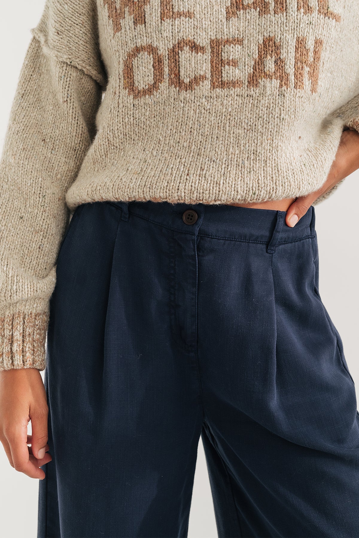 close-up of front button and elastic waistband pants.