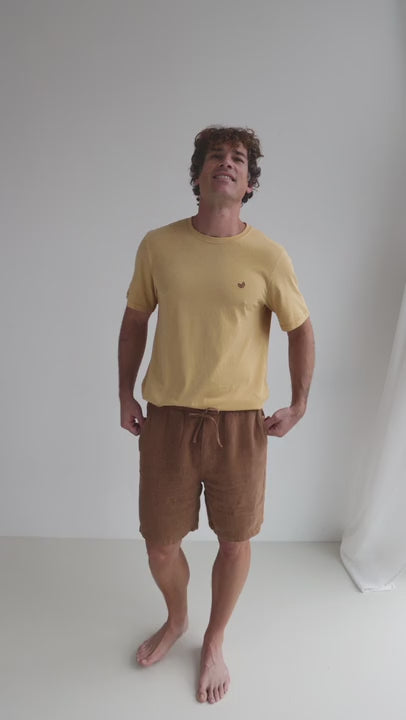Adobe heavy linen shorts men yellow shirt full body view