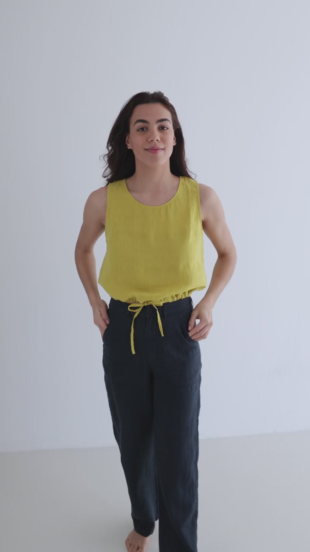 Golden green sleeveless linen shirt women navy blue pants full body view 