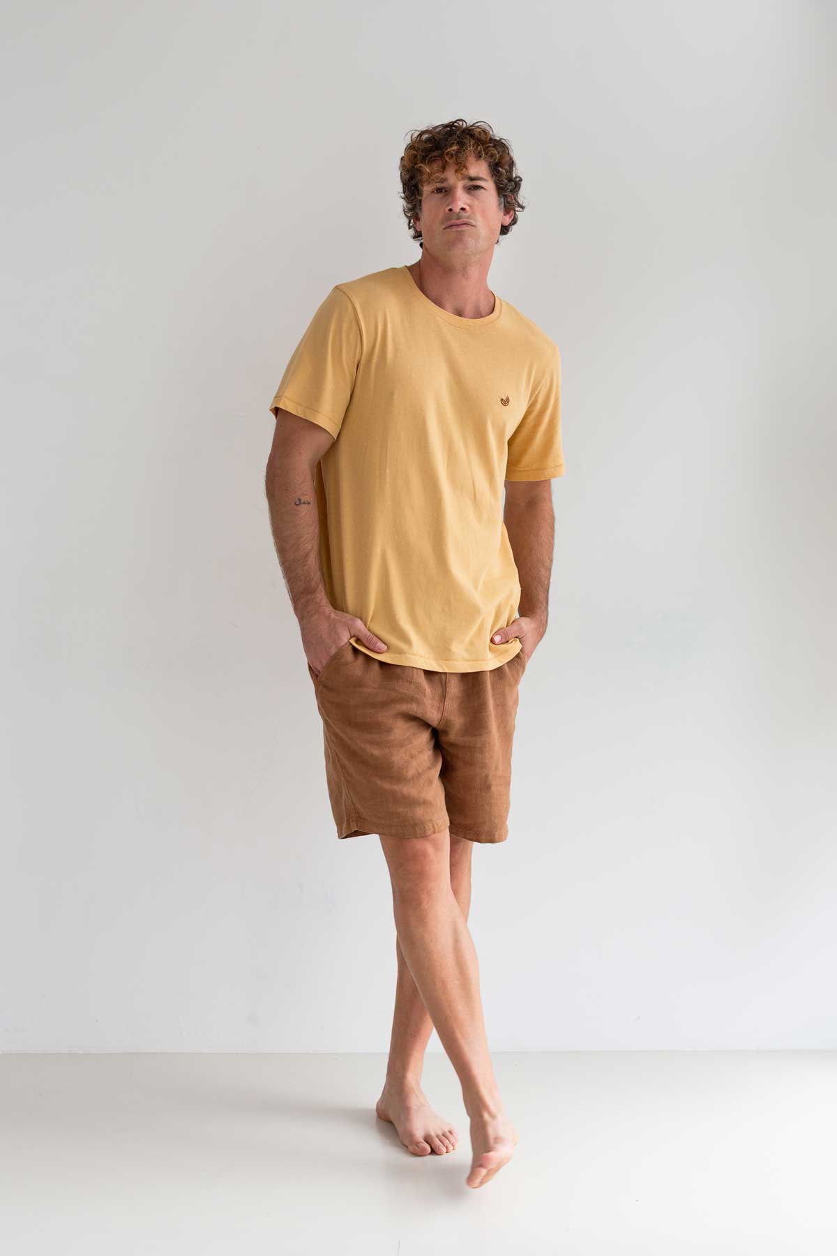 Yellow t-shirt men brown shorts full body view front
